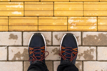 Man standing at the tactile paving