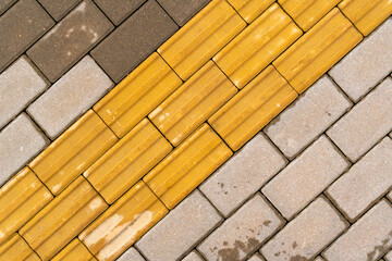 Sidewalk with yellow tactile paving