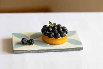 cake with fresh berries, blueberries on a light background