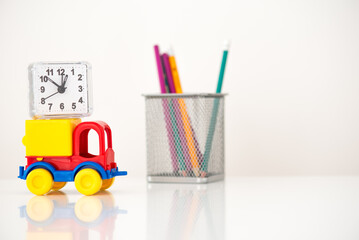 Watches, trucks stationery on a white table. Time of delivery.