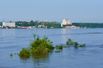View of the river port during flooding. Flooded treetops.