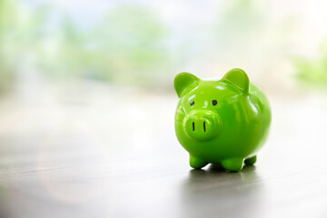 Green piggy bank saving, accounting, banking and business account or sustainable and environmentally friendly finance - 500880274