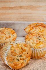 cheese and herb savory muffins baked to cheesy perfection on a rustic surface