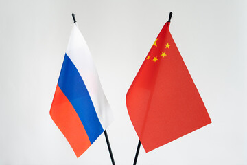 State flags of Russia and China on white background.Cooperation business alliance sanctions concept