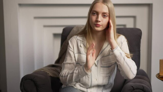 4k Young woman telling story to psychologist and sitting on sofa in modern office spbas. Close view european worried female speaks and shows stress or frustration, professional listens and sits in