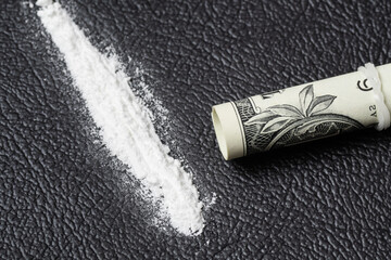 A line of cocaine powder and dollar bill scroll. Conceptual mockup of illegal drug dealing, trafficking, war on drugs. - obrazy, fototapety, plakaty