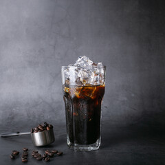  coffee of americano iced coffee on glass and roasted coffee beans on a black background studio photo