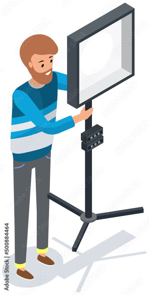 Poster lighting specialist installs softbox to diffuse light. technician works with softbox, spotlight on s