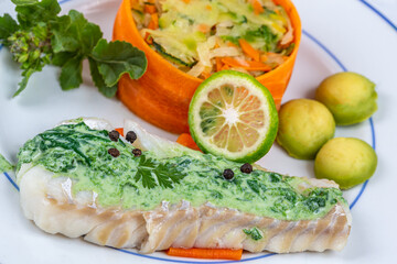 Plate of cod and vegetables with sorrel sauce