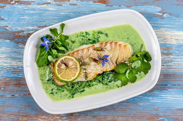 Close-up of grilled cod back on sorrel sauce,