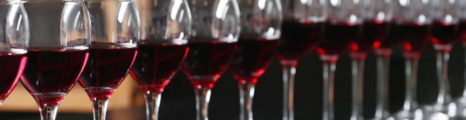 Glasses with tasty red wine, closeup view. Banner design