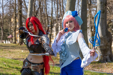 two women as cosplay figures in a forest - obrazy, fototapety, plakaty