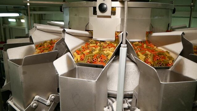 Special device for sorting and packing pasta at the factory.
Colored pasta in the form of tubes is poured to the bottom and sorted.