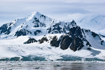snow and ice covered mountains and glacier at Petermann Island, Antarctica