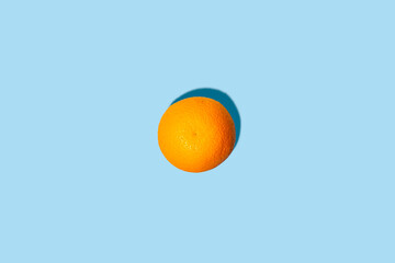Fresh orange on a blue background. Top view, flat lay.