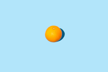 Fresh orange on a blue background. Top view, flat lay.