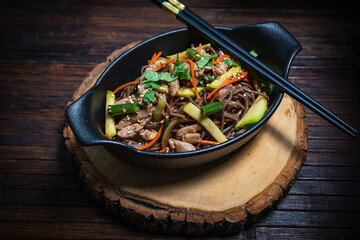 Asian style- restaurant background. Udon noodles with beef Wok