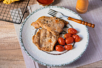Grilled pork steak with tomatoes.Top view
