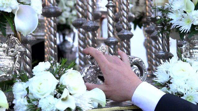 Detail of the knocker or llamador at the moment when it is hit by the foreman of the brotherhood to lift the Holy Week platform or throne
