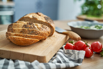 Bread in slices on wooden board
