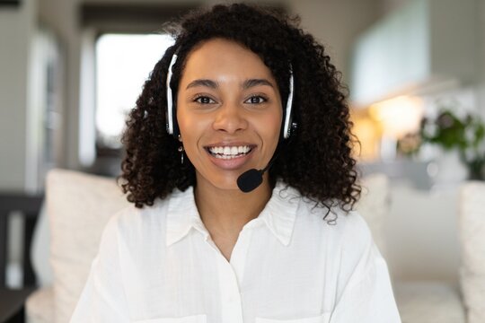 Close up screen view headshot portrait of happy millennial african american woman in headphones talk on video call