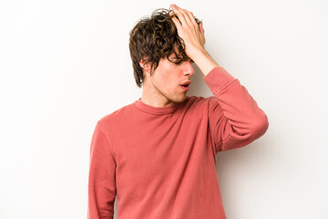 Young caucasian man isolated on white background forgetting something, slapping forehead with palm and closing eyes.