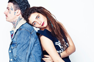 Young couple together. guy with tattoo, girlfriend wearing dreadlocks having fun on white background