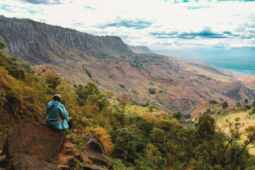 Rear view of a hiker at a scenic view point in Kerio Valley, Elgeyo Marakwet, Kenya