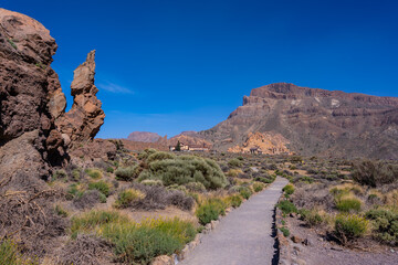 Path to walk between the Roques de Gracia and the Roque Cinchado in the natural area of Mount Teide in Tenerife, Canary Islands