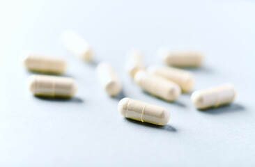  Selenium capsules. Concept for a healthy dietary supplementation. Bright paper background. Soft focus. Close up. Copy space.