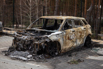 Hostomel, Kyev region Ukraine - 09.04.2022: Cities of Ukraine after the Russian occupation. Cars burned down on the street. Irpin, Bucha, Gostomel.