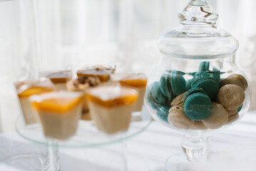 Various desserts and cake on the buffet table at the wedding