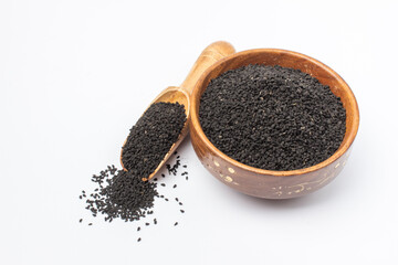 Kalonji or  nigella sativa seeds in wooden spoon on white background
