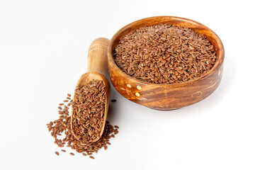 Flaxseed in wooden bowl and spoon on white background