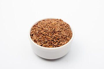 Flaxseed in white bowl on white background