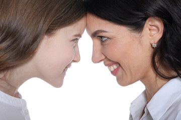 Portrait of happy mother and daughter posing on white background