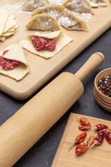 Rolling pin, allspice and pepper pods on table.