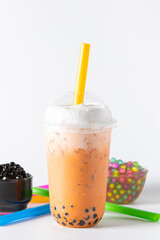 Traditional beverage of asia taiwan,  Ice buble or boba milk tea in plastic cup with straw on white background, summers refreshment.