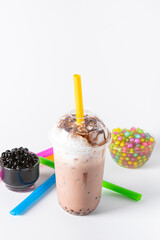 Traditional beverage of asia taiwan,  Ice buble or boba milk tea in plastic cup with straw on white background, summers refreshment.