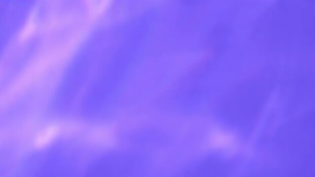 Abstract pink colourful caustic light effect on purple backdrop. Very peri water texture background stock footage. Lens light leaks flashing around making beautiful animation
