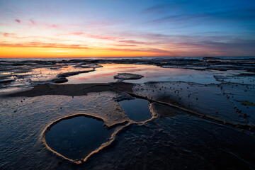 Newcastle beach Rock shelf at sunrise with rock pools, Newcastle, Merewether, NSW, Australia