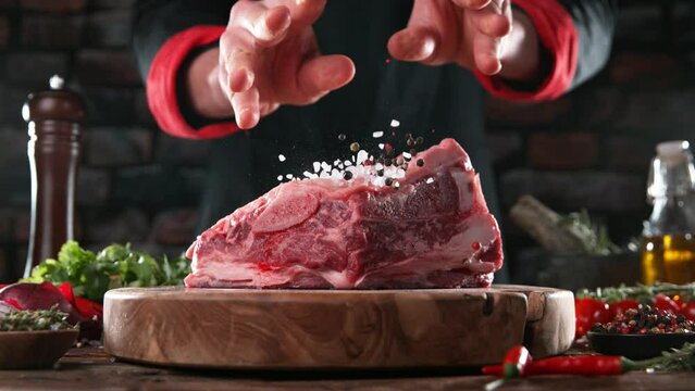 Close-up of falling salt on tasty beef steak in kitchen, super slow motion, filmed on high speed cinematic camera at 1000 fps.