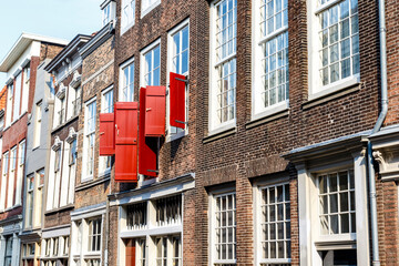 Naklejka premium Street with old Dutch houses in Dordrecht, Zuid-Holland, The Netherlands, Europe