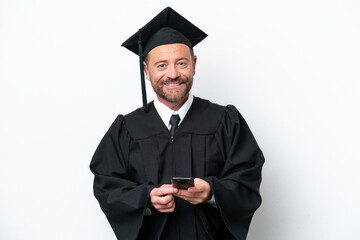 Middle age university graduate man isolated on white background sending a message with the mobile