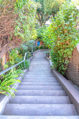 Concrete u-shaped outdoor staircase with two landings in the middle at San Francisco, California