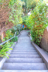 Fototapeta premium Concrete u-shaped outdoor staircase with two landings in the middle at San Francisco, California