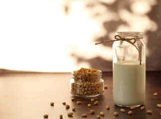 fermented milk product kefir in a glass jar with pine nuts on a beige background