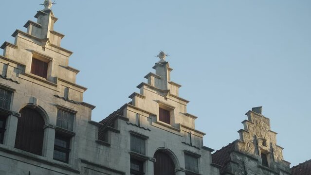 Old European rooftops in Belgium with jet streams and sunset shadows motion time lapse HD