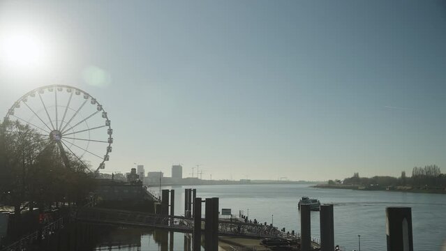 Antwerp Belgium river harbor with boat and Ferris wheel slow motion 4k 30p