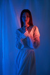 Beauty fashion woman in light white dress in studio. Freedom concert in neon color light. Fashion...